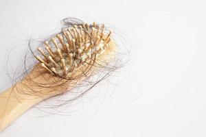 Hair loss fall with comb brush isolated on white background. photo