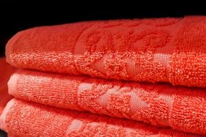 Stack of bath towels. Home textiles for spa treatments. Soft fluffy fabric. photo