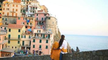 Happy couple background stunning village of Manarola, Cinque Terre, Liguria, Italy video