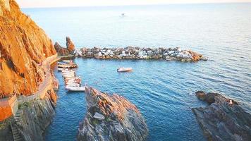 Beautiful cozy bay with boats and clear turquoise water in old village in Cinque Terre, Italy, Europe video