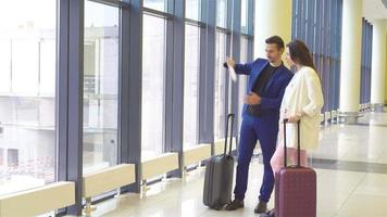 Couple with baggage in international airport. Man and woman going on landing video