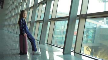 Adorable little girl with baggage in airport waiting for boarding video