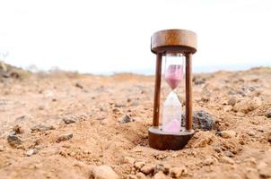 Hourglass on the ground photo