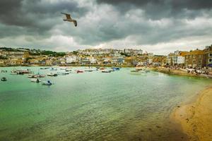 Dramatic cloudscape and scenic panorama of beach of St Ives coastal town, Cornwall, England photo