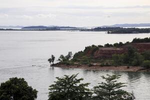 Sea side of the island and another island at the horizon. photo