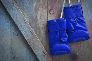 Blue leather boxing gloves hanging photo