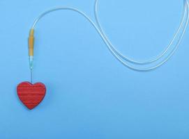 plastic catheter with needle and red heart photo