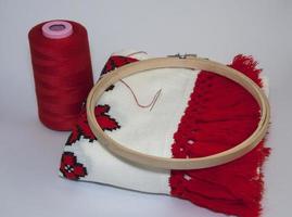 Traditional embroidered towel with red thread on white background photo