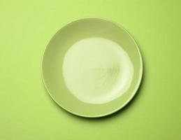 empty round green plate for main courses on a green background photo