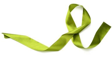 rolled green silk ribbon on white background, gift wrapping decor photo