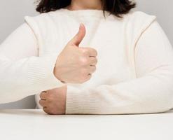 woman showing like gesture with left hand, approval and recommendation photo