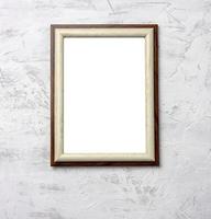 wooden frame hanging on white cement wall photo