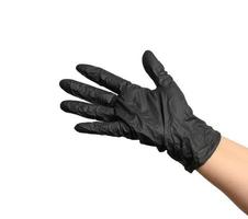 mano femenina en un guante de látex negro sobre un fondo blanco foto