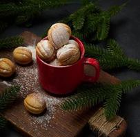 Baked nut-shaped dessert in a red ceramic mug photo
