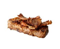 fried piece of beef with pieces of fried bacon isolated on white background photo