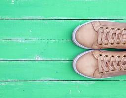 top view of a pink pair of female leather sneakers photo