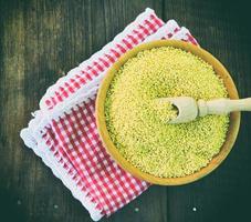 Millet cereal in a wooden plate photo