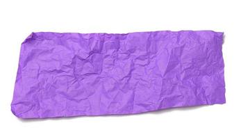 piece of crumpled purple gift wrapping paper isolated on white background photo