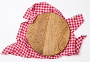 empty round wooden cutting kitchen board on a white background, pizza board, copy space photo