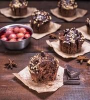 chocolate muffins on a brown wooden background photo