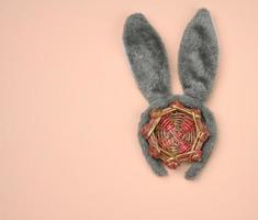 rabbit mask on the head with ears on a beige background, festive backdrop photo