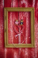 Wooden frame with carved wooden heart inside photo