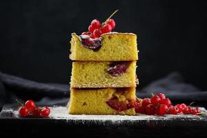 A stack of square slices of baked plum biscuit cake photo