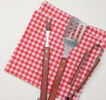 metal kitchen items with wooden handles for barbecue on white background photo