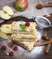 baked slices of pie with apples on a brown wooden board photo