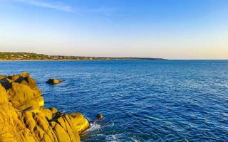 Beautiful rocks cliffs surfer waves panorama view Puerto Escondido Mexico. photo