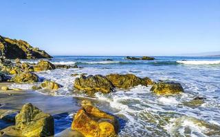 Beautiful rocks cliffs surfer waves at beach Puerto Escondido Mexico. photo