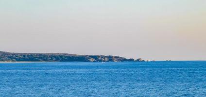 Beautiful rocks cliffs surfer waves panorama view Puerto Escondido Mexico. photo