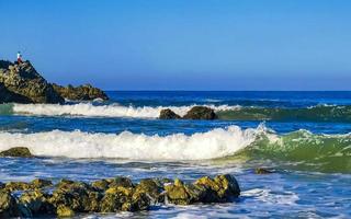 Beautiful rocks cliffs surfer waves at beach Puerto Escondido Mexico. photo