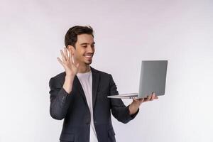 Portrait of young handsome smiling businessman video call via laptop in hands, isolated on white background photo