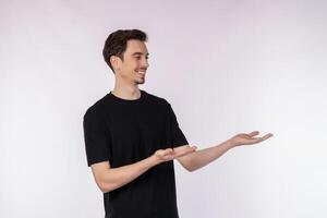 Portrait of happy smiling young man presenting and showing your text or product isolated on white background photo