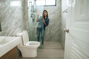 Young woman in bathroom and restroom photo