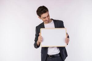 retrato de un hombre de negocios feliz que muestra un cartel en blanco sobre un fondo blanco aislado foto