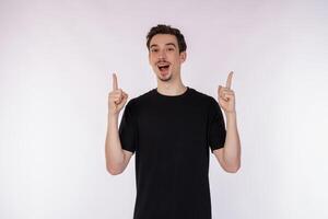 Portrait of happy young man having great idea over studio background photo