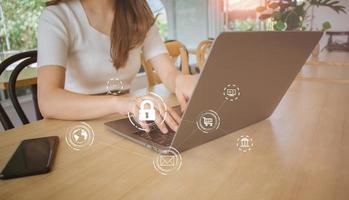 Female using computer laptop screen with padlock in cafe. user privacy security and encryption, secure internet access future technology and cybernetics, internet security, cybersecurity concept. photo