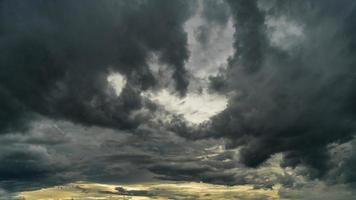 Dramatic storm clouds at dark sky photo