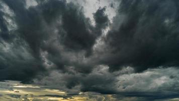 Dramatic storm clouds at dark sky photo