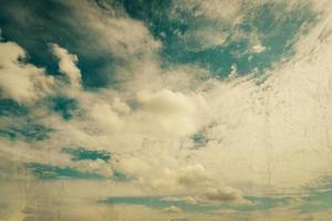 clouds and blue sky with grunge scratch effect vintage photo
