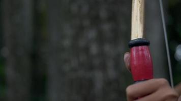 Asian Women ready to shoot an arrow from the bow while standing bravely video