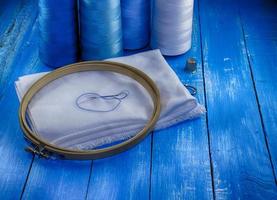 White fabric and thread in blue, toning photo