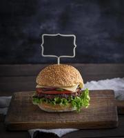 hamburger with meat patty and fresh vegetables photo