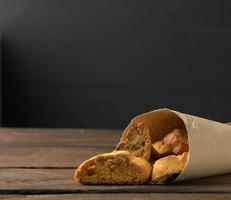 pieces of baked italian christmas biscotti cookies, wooden background photo