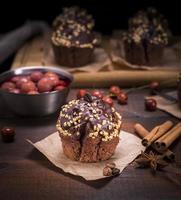 muffin sprinkled with nuts on a brown piece of kraft paper photo