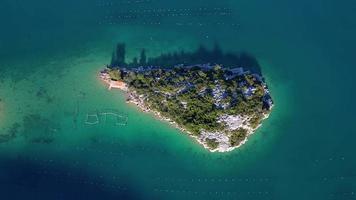 Aerial drone view of a small island in the bay of Mali Ston located on Peljesac peninsula. Oyster farms in the turquoise sea water. Unique mix of freshwater and seawater. video