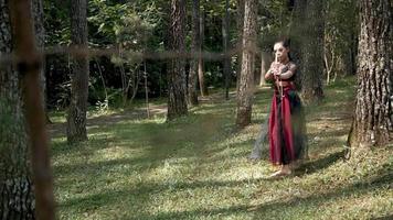 Archery woman hunting an enemy inside the forest with an arrow and a bow video