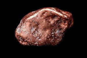 Macro mineral stone of a copper nugget on a microcline on a black background photo